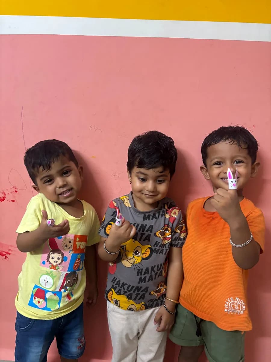 Children showcasing bunny finger puppets during interactive puppet story circle