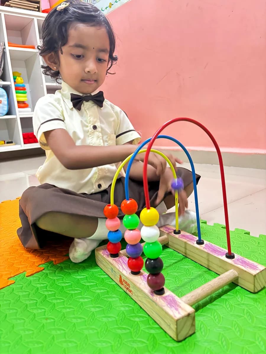 Young child solving cognitive shape matching and memory blocks puzzle