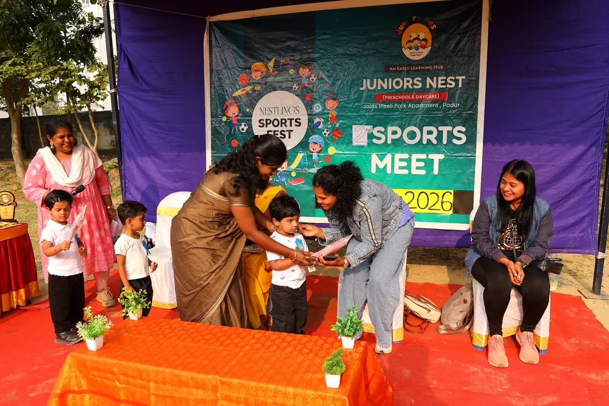 Children proudly showing their gold medals on the sports day winner podium