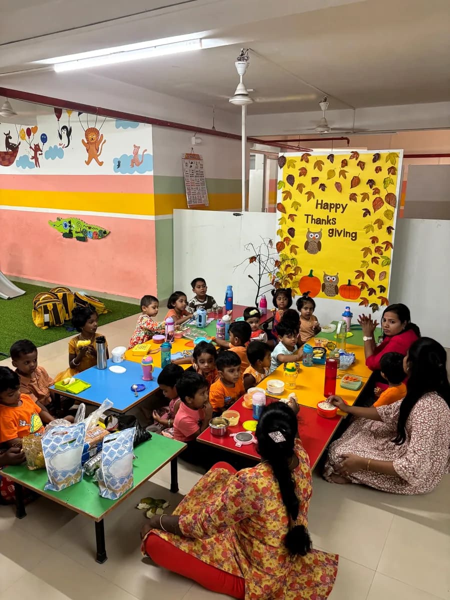 Teachers and children seated together sharing meals and learning Thanksgiving values